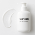 A clean white bottle of non-comedogenic moisturizer with a gentle cream smear.