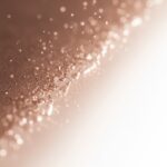 Glycolic Acid for Skin: Benefits, Risks, and How to Use It 3 Glycolic acid for skin-Abstract image showing a rough, textured surface transforming into a smooth, glowing surface, representing the effects of exfoliation.