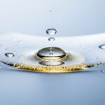 Squalene for Skin: Hydration, Barrier Support, and How to Use It 9 A macro image of water droplets held within a golden liquid, representing how squalene for skin locks in hydration and supports the skin barrier